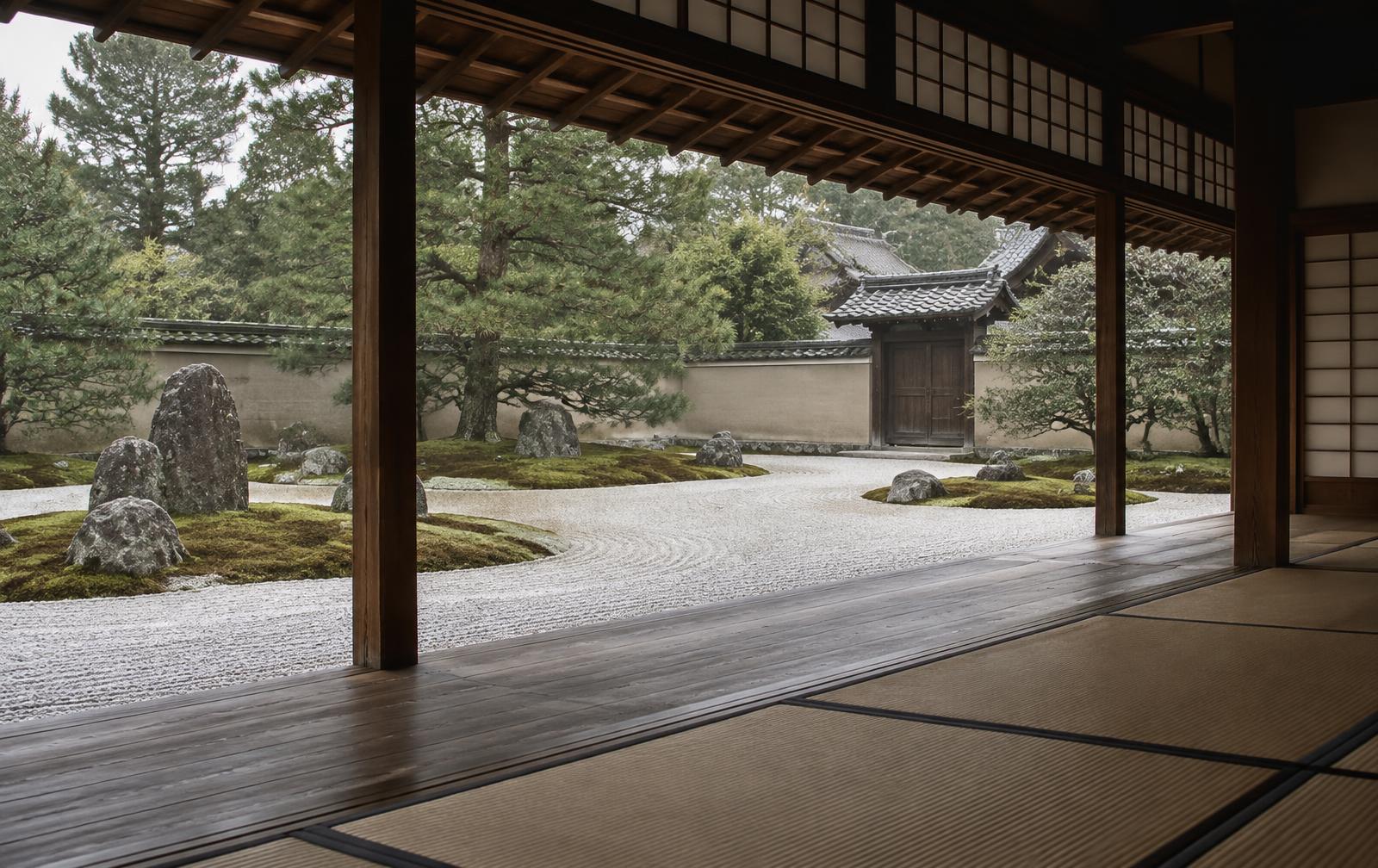 View from a quiet tatami veranda onto a raked white gravel and green moss karesansui Zen courtyard garden at Daitoku-ji in Kyoto